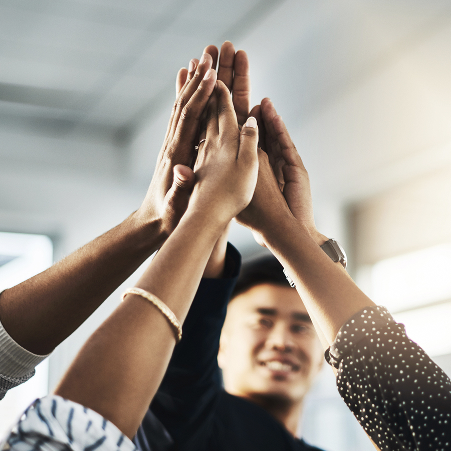 A group of people giving each other a high five.